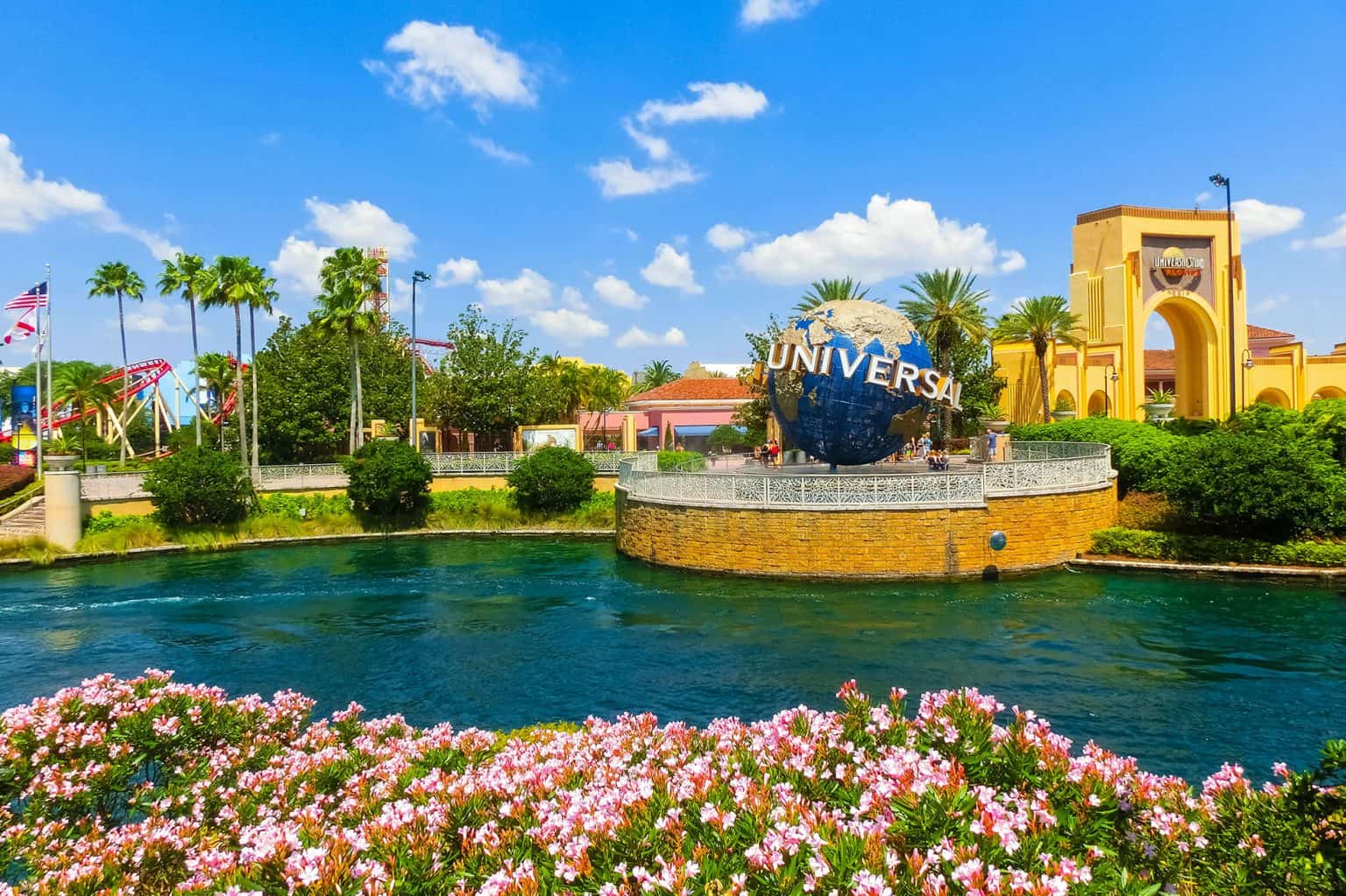 Beautiful scene of Universal Studios in Florida, featuring the globe and park rides at sunset.